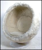 A late 20th Century retro pod chair raised on tulip white finished metal plinth base,