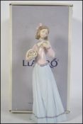 Lladro figure of a lady with flowers 