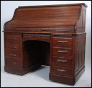 An early 20th century large oak roll top tambour office desk.