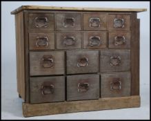 An early 20th century Industrial 14 drawer beech wood filing - storage cabinet - chest of drawers -