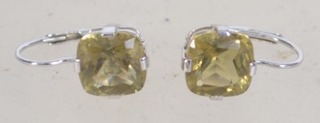 A pair of 9ct white gold drop earrings with yellow stone. Weight 2.4g.