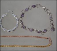 A small collection of silver jewellery to include a pair of large hoop earrings,