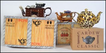 A collection of three boxed large limited edition collectors novelty teapots by Paul Cardew to