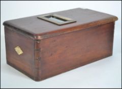 An early 20th century mahogany oblong shaped self closing counter top shop till by O`Briens.
