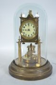 An early 20th century Angemeldet patent brass torsion anniversary clock complete in the brass dome