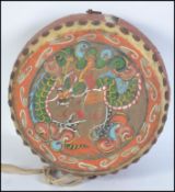 A 20th century Chinese style temple drum having animal hide drum skins painted with flora and