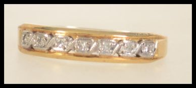 An 18ct gold 7 stone diamond ring. Marked 18ct tests 18ct gold. Size O. Weight 2.5g.