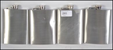 A group of four silver plater / steel hip flasks each with screw top caps. Measures 14cms high.