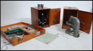 2 vintage mid century scientific wooden cased microscopes together with a large wooden case of