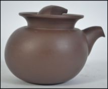 A Chinese yi-xing teapot ( tea pot ) dating to the 20th century being finely potted from terracotta.