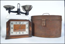 A Victorian tin hat box of oval form with hinged lid together with a 1930's Art Deco mantel clock