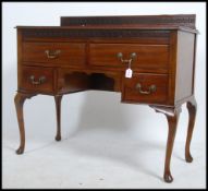 An Edwardian mahogany and leather writing table desk.