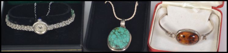 A group of jewellery items to include an amber ? pendant on a silver chain,