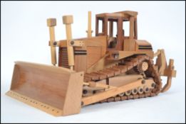 An impressive large hand carved and crafted wooden American bulldozer being fully articulated with