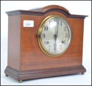 An Edwardian early 20th century satin wood inlay eight day mantel clock with makers marks to