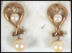 A pair of hallmarked 9ct gold and pearl drop earrings. Hallmarked London. Total weight 3g .