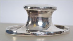 A silver hallmarked capstan style ink well having a hinged lid with assay marks for Birmingham,