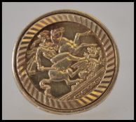 A 9ct gold gentlemans sovereign ring having inset 1979 9ct gold St George & Dragon token coin.