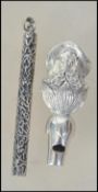 A silver whistle stamped 925 in the form of a maiden together with a rococo cylindrical silver