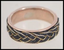 A 15ct gold Victorian band ring set with a filigree and elephant hair plat. Size.T.5.