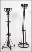 A pair of 20th century tall wrought ebonised metal candle stands.