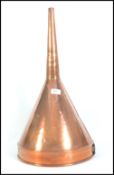 A large 19th century oversized copper wine funnel with shaped rim having typical form with open