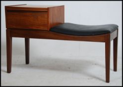 A 1970's retro teak wood Mr Chippy telephone table being raised on squared legs with drawer and