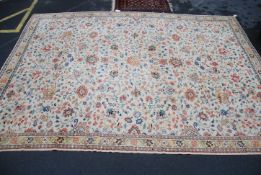 A large 20th century floor rug of yellow ground with foliates and hunting lion and deer scenes with