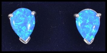 A pair of ladies silver pear shaped blue opal stud earrings complete in a presentation case
