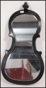 A 20th century fiddle backed wall mirror in the form of a violin.