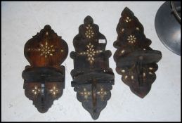 A set of 3 vintage hardwood and mother of pearl anglo-Indian colonial wall brackets for clocks -