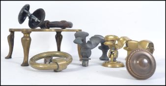 A collection of vintage brass door knockers to include brass Victorian examples, brass trivet,