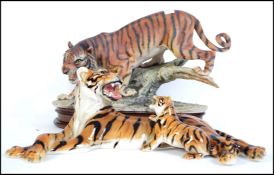 Two ceramic figurines of tigers.