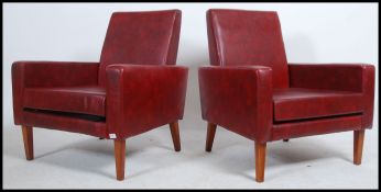A pair of vintage retro mid 20th century club armchairs.