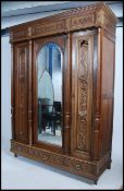 A large 19th century French country oak triple wardrobe.