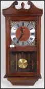 A 20th century wooden cased 31 day wall clock. Measures 71cms high x 32cms wide x 13cms deep.