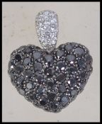 A Chopard 18ct white gold and diamond figural pendant in the form of a heart encrusted with white