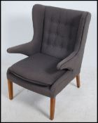 A good 20th century Danish armchair in teak in the manner of Hans Wegner being raised on tapered