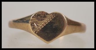 A 9ct gold hallmarked band ring with heart shaped centre being etched. London hallmarks for 1991.