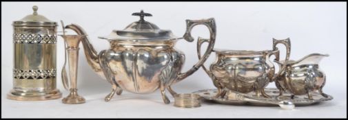 A collection of silver plate items to include teapot, sugar bowl and creamer.
