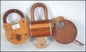 An impressive hand carved collection of 3 large wooden padlocks complete with keys and working.