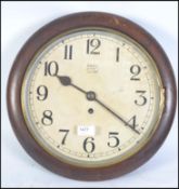 A mid century oak cased station wall clock marked ANVIL to white enamel face .