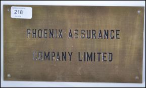 A vintage 20th century Industrial brass advertising wall plaque sign for ' Phoenix Assurance '.