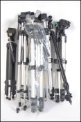 A large collection of photographic tripods to include various sizes, some by Slik.
