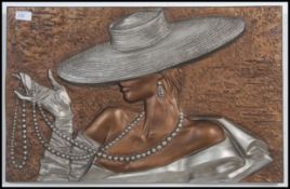 An Art deco style molded 3D effect plaster picture of a young stylistic lady in hat smoking a