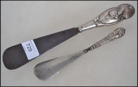 Two early 20th century silver handled shoe horns.