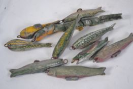 A collection of vintage mid 20th century wooden hand carved and painted fishing lures.