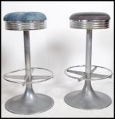 A pair of 1950's chrome American diner bar stools having circumferential stretchers,