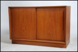 A good Danish 1970's teak wood sideboard cabinet raised on an inset plinth base with twin sliding