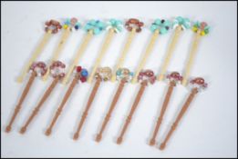 A collection of turned wood lace bobbins, to include examples with inlaid wire,